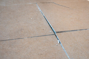 Cracked floor tiles from bad Tile installation services