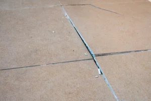 Cracked floor tiles from bad Tile installation services