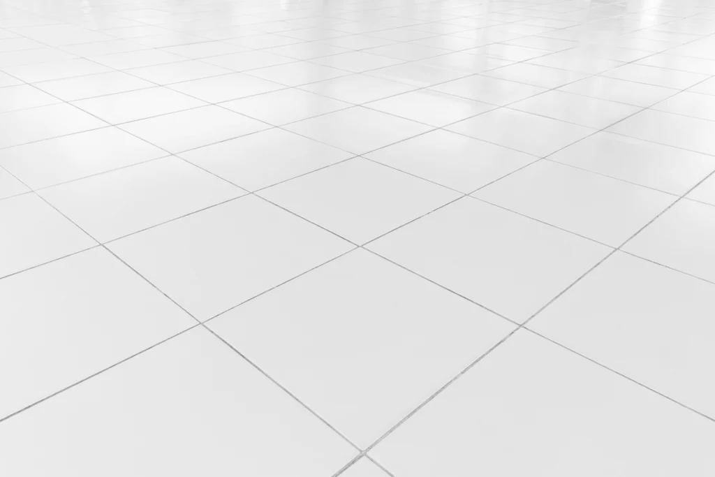 A good tile installation white tile floor clean condition with grid line for background.